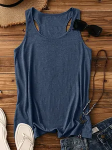 Flat lay of a denim blue racerback tank top with summer accessories on wooden background