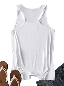Flat lay of a white ribbed racerback tank top paired with denim shorts and flip-flops