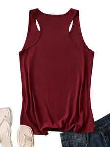 Close-up flat lay of a wine red racerback tank top paired with denim jeans and flip flops