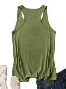 Flat lay of an olive green racerback tank top paired with denim jeans and sandals