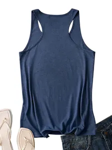 Flat lay of navy racerback tank top paired with white flip-flops and denim shorts