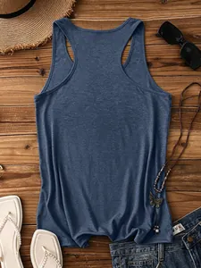 Detail of navy blue racerback tank top with straw hat and sunglasses on wood background