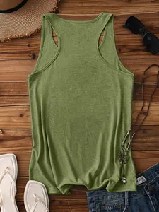 Flat lay of an olive green racerback tank top with summer accessories on wooden background