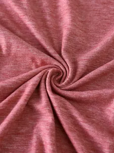 Macro detail of soft heather red knitted fabric texture with subtle jersey weave pattern