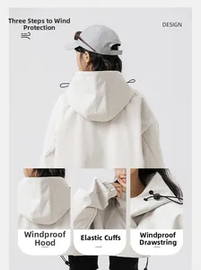 Detail of light beige windbreaker showing hood, elastic cuffs and adjustable drawstring hem