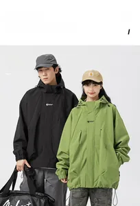 Detailed view of the loose-fitting hooded jacket with chest logo and shoulder panels