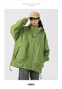 Detail of green oversized hooded cargo jacket with black chest print and sleeve zipper