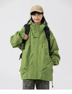 Detail of army green hooded windbreaker with black text print and oversized pocket
