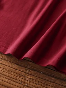 Detail of dark red knit tank top showing high-quality double-needle hem stitching and fabric