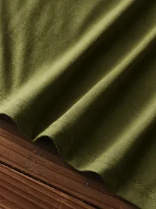 Detail of army green knit fabric with neat double-needle stitching and soft texture