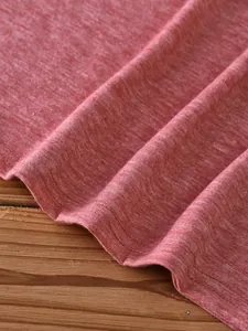 Detail of twin-needle stitching on heather red knitted hem of a casual tank top
