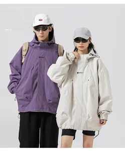 Detail of hooded windbreaker featuring functional drawstring and stylish chest embroidery