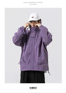 Detail of purple hooded windbreaker featuring loose fit design and zipper pockets