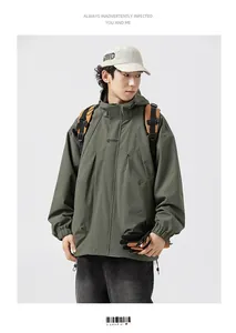 Close-up of military green hooded outdoor jacket with stand collar and pocket details