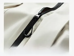 Close-up of waterproof zipper and durable fabric on men's outdoor hooded jacket