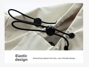 Detail of adjustable drawstring system on beige outdoor jacket hood for personalized fit