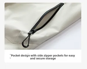 Detail of waterproof zippered side pocket on beige outdoor jacket with ergonomic U-shaped pulls
