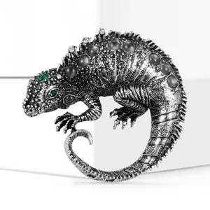 Macro detail of lizard brooch in antique silver finish with grey pearls and scale texture