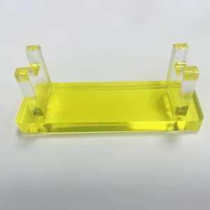 Macro detail of translucent yellow acrylic pen display stand with double U-shaped supports