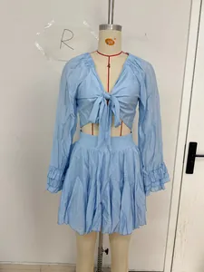 Detail of light blue two-piece set featuring a V-neck tie top and tiered ruffled skirt