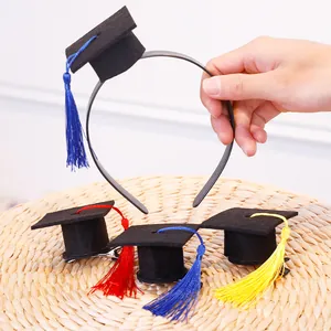 Detail of graduation mini mortarboard headbands and hair clips with colorful tassels