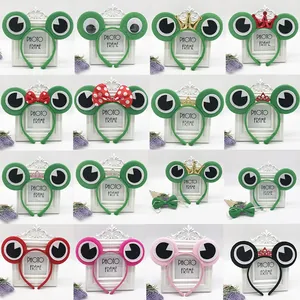 Detailed grid of plush green frog headbands with various crowns and bow accessories