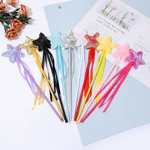 Close-up of sparkling sequin star wands in multiple colors with hanging ribbons