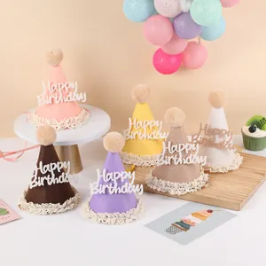 Close-up of birthday party hats with Happy Birthday lettering and soft plush pompom