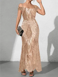 Close-up of geometric sequin embroidery on champagne gold slim fit evening gown