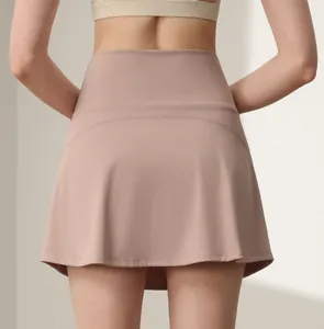 Detail of high-waisted dusty pink tennis skirt with curved back seams for fitness
