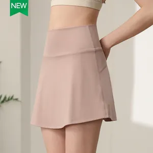 High waisted nylon tennis skirt with side pockets and built-in shorts in dusty pink color