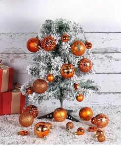 Detail of orange Christmas ornaments set with matte, glitter and snowflake patterns