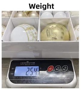 Detailed view of Christmas decorative ball set in gift box being weighed on a scale