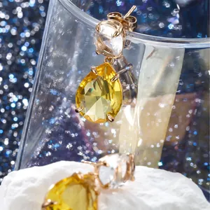 Elegant rose gold earrings with teardrop yellow gemstone and clear round crystal accents