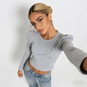 Detail of grey long sleeve tee featuring vintage puff sleeves and corset-style stitching