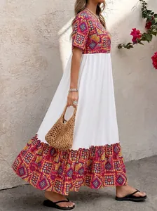 Bohemian maxi dress detail showing flowing tiered A-line skirt with ethnic geometric print