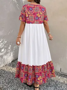 Back view of a Bohemian maxi dress featuring a white contrast panel and geometric prints