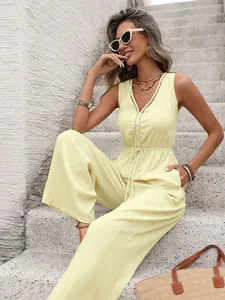 Close-up of sleeveless V-neck jumpsuit with delicate lace trim and textured fabric