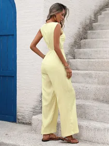 Detail of light yellow sleeveless jumpsuit with textured fabric and high waist design