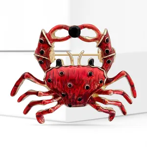 Detail showing the red enamel finish and gold alloy trim on the crab-shaped brooch