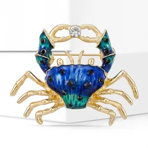 Macro view of blue enamel crab brooch with gold plating and sparkling crystal detail