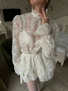 Elegant ivory lace two-piece set with high neck lantern sleeves and tiered cake skirt