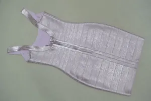 Detail of metallic pink bandage dress showing high-quality fabric texture and back zipper