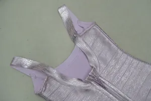 Close-up of lavender dress with metallic silver stripes and back zipper closure