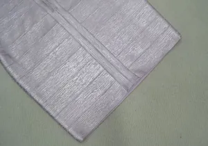 Detailed macro view of light purple metallic texture fabric and stitching on party dress