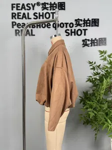 Detailed side view of brown faux suede bomber jacket on a mannequin with lapel collar