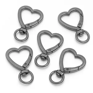 Close-up of five gunmetal heart-shaped lobster clasps for DIY jewelry and bags