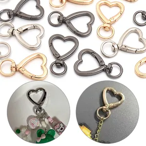 Close-up of heart-shaped lobster clasps in gold, silver and bronze for DIY crafts