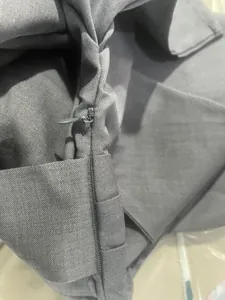 Macro detail of high-quality grey twill fabric featuring a seamless hidden zipper