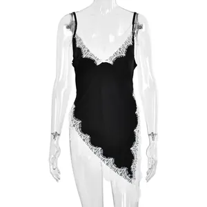 Detail of V-neckline with delicate white eyelash lace on black satin slip dress